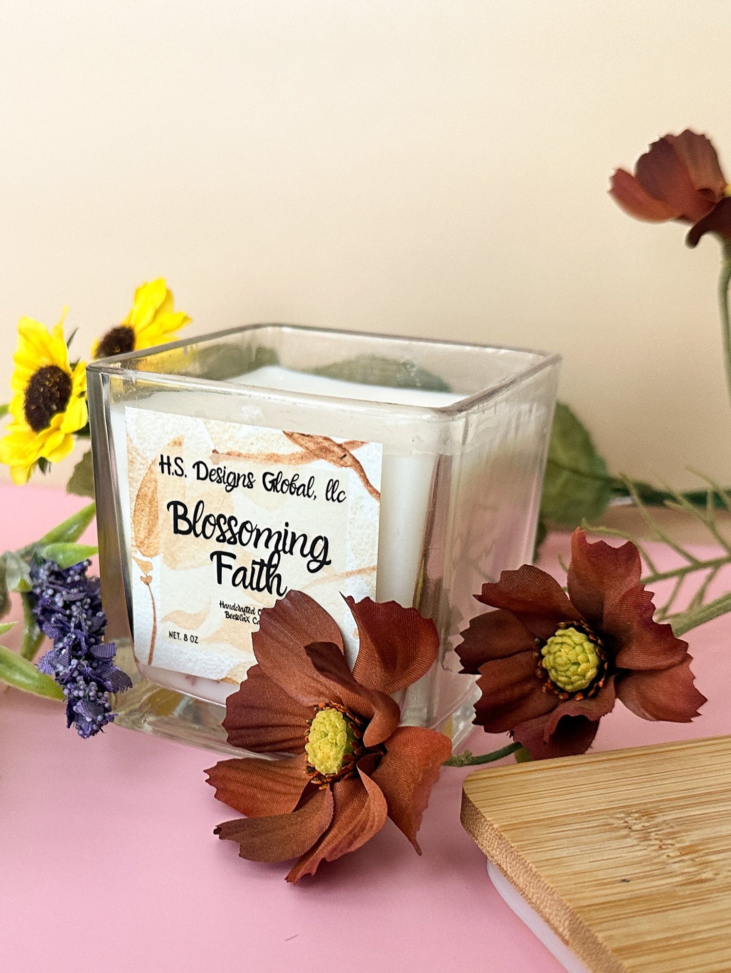 square scented candle with flowers around