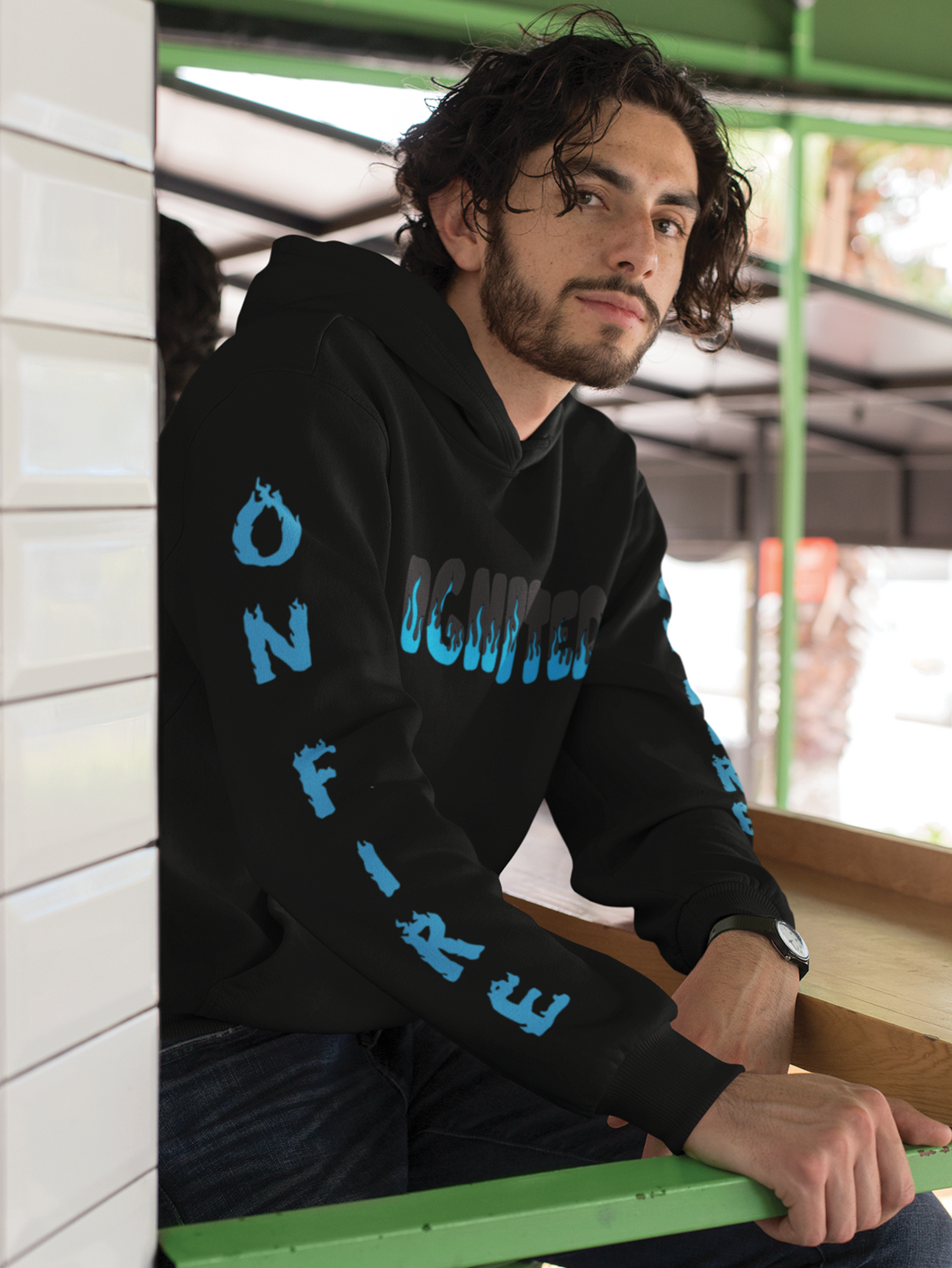 man in black hoodie with blue and black text on sleeve and chest